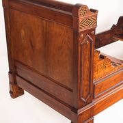 Bed made of solid walnut with marquetry details. France, 1930s.