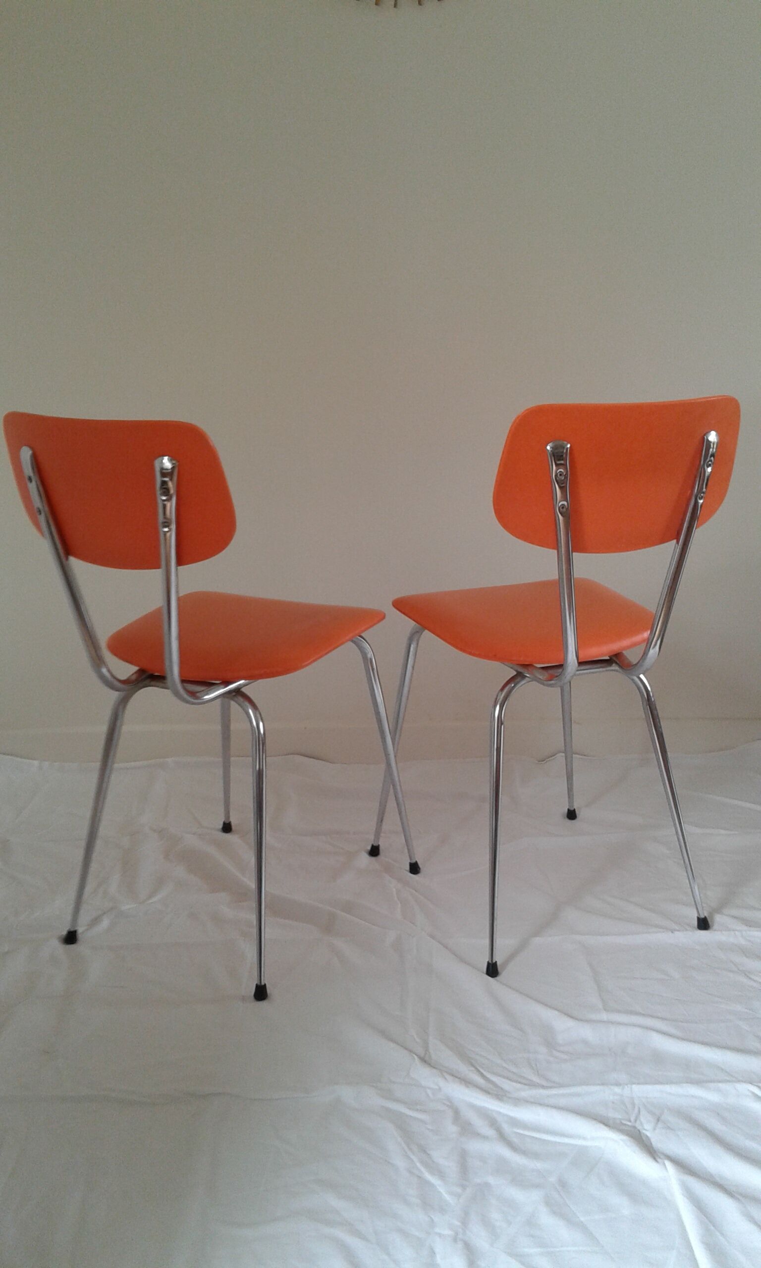 Duo of vintage chairs in orange skai