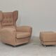 Beige wingback armchair and TVAR footrest, former Czechoslovakia.