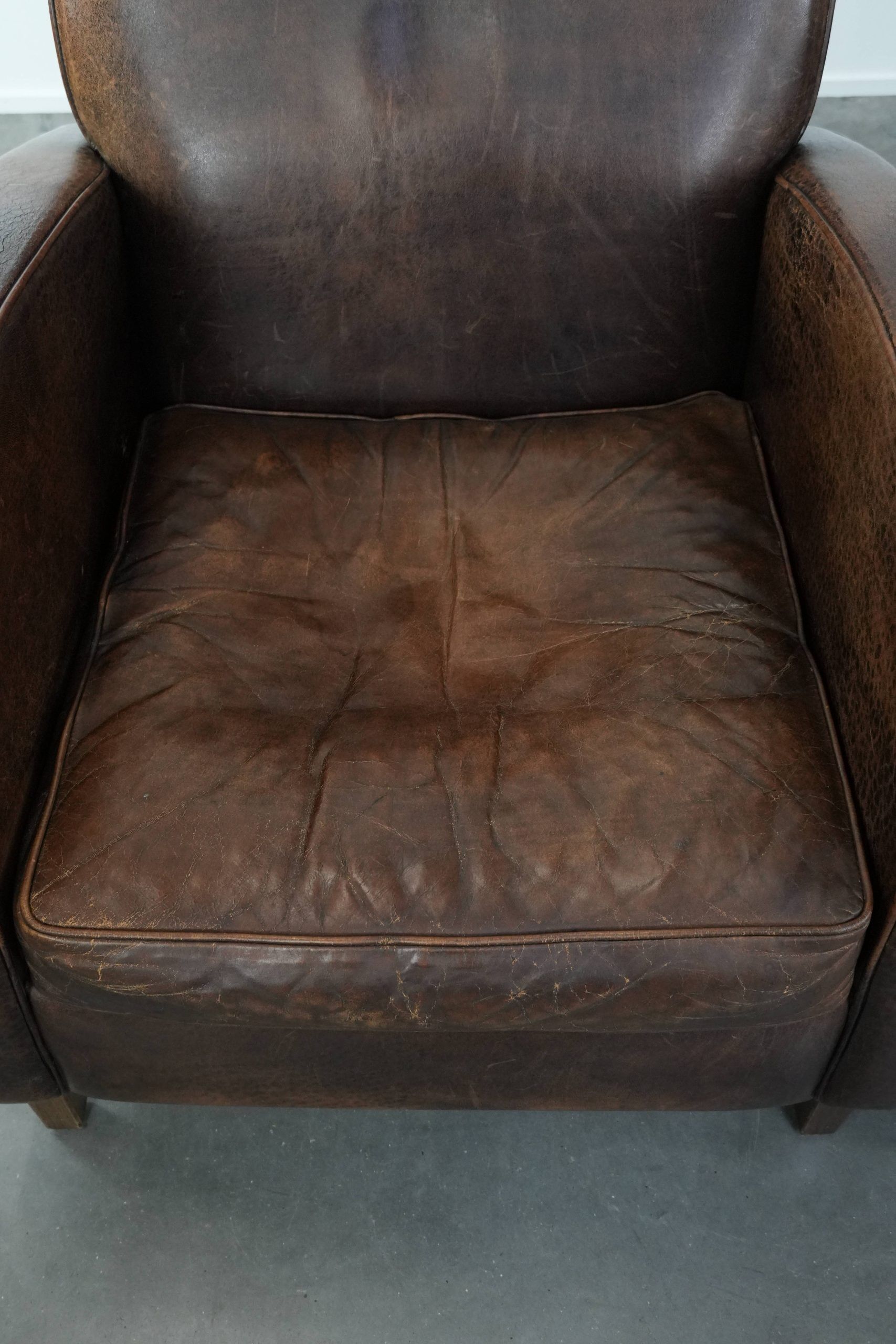 Set of two vintage sheepskin leather design armchairs in a cognac colour