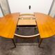 Scandinavian table in round teak with built-in extensions 1960
