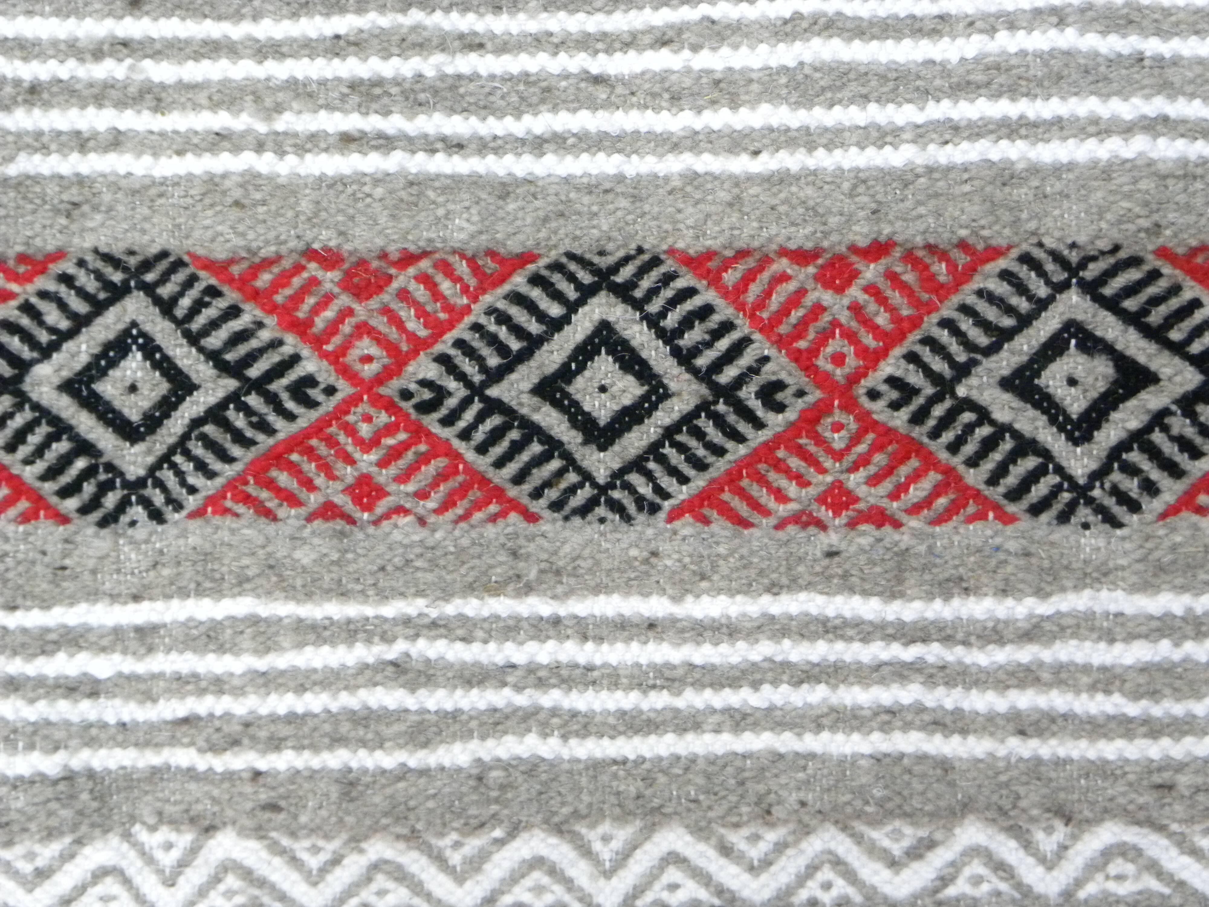 Geometric woven rug with fringes – Ethnic style – Hallway & interior
