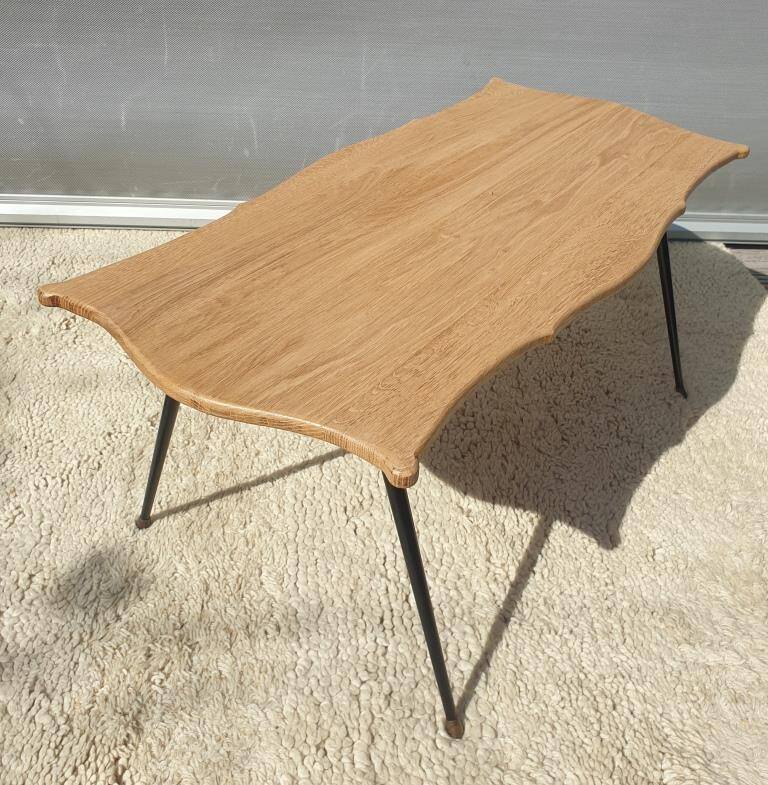 Violin-shaped coffee table with brass legs