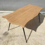 Violin-shaped coffee table with brass legs