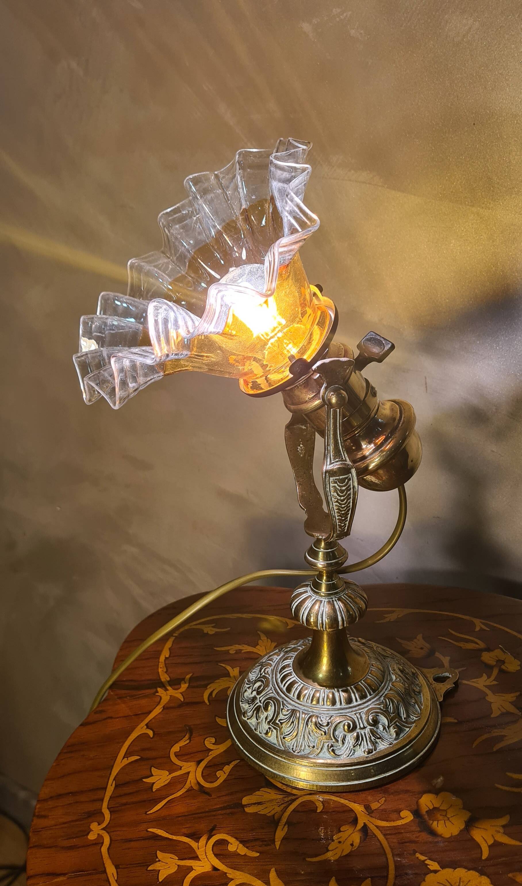 1920 bronze and brass rocking lamp with translucent amber-colored shade