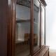Large glass-fronted library in rosewood from the 19th century.