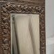 Bevelled mirror from the 1930s in repoussé brass.