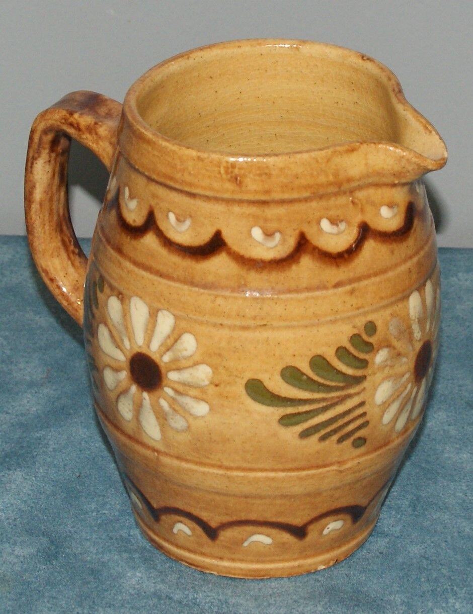 Glazed terracotta pitcher decorated with friezes and flowers