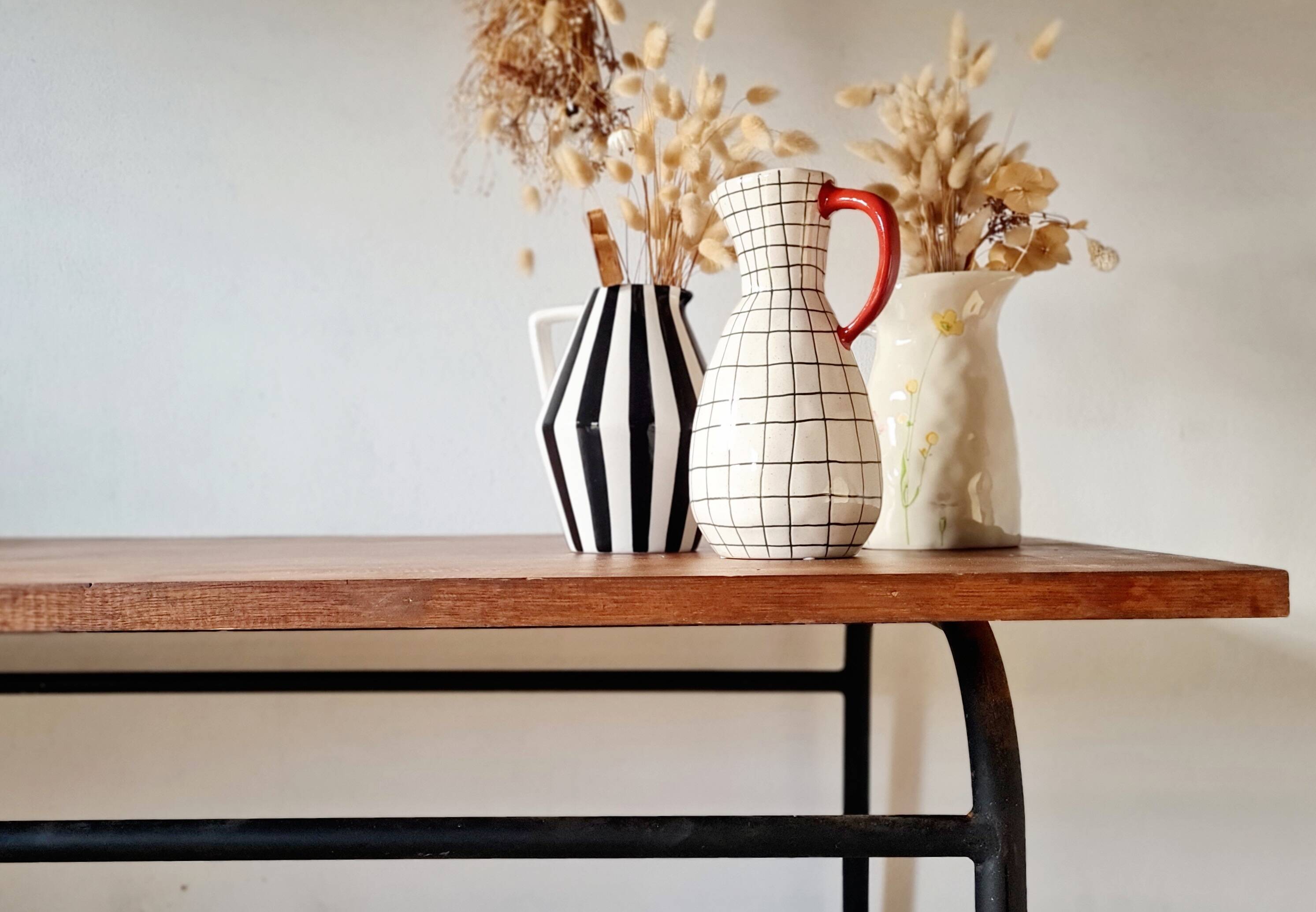 Table with tubular metal legs and wooden top.