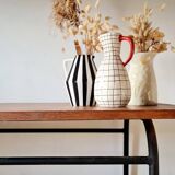 Table with tubular metal legs and wooden top.