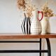 Table with tubular metal legs and wooden top.
