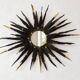 Large brutalist sun mirror in patinated metal with gold accents, 1970.