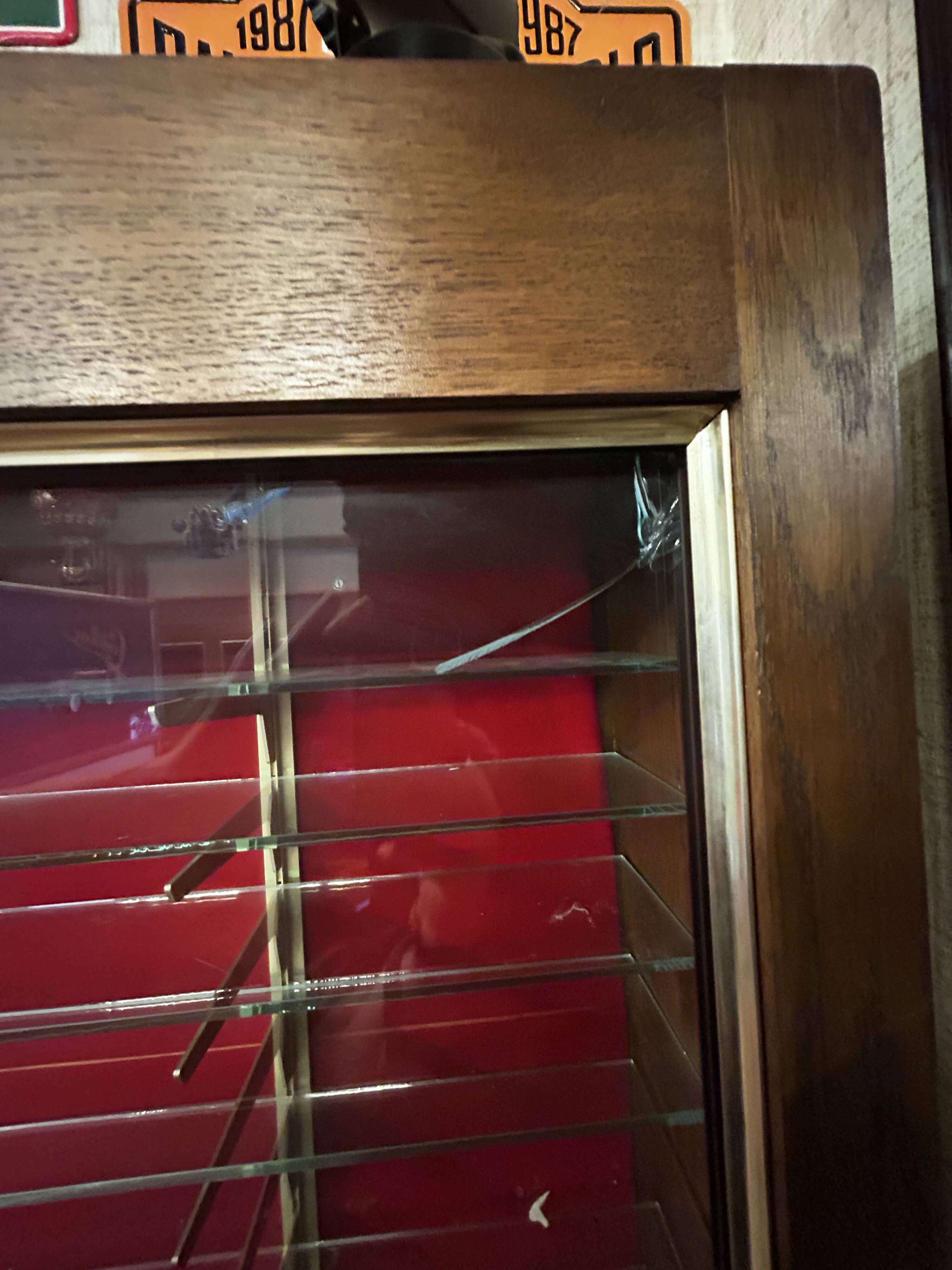 Large vintage display cabinet in wood and glass – red background, 15 shelves
