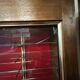 Large vintage display cabinet in wood and glass – red background, 15 shelves