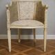 Gondola armchair in Louis XVI style, carved wood with a cream patina.