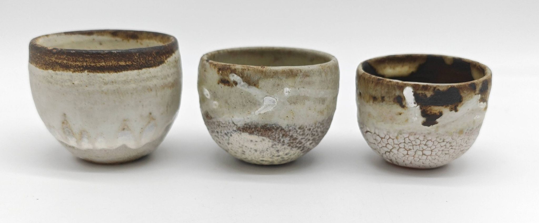 Trilogy of cups or Japanese-style goblets by the Danish ceramist Gutte Eriksen using RAKU technique.