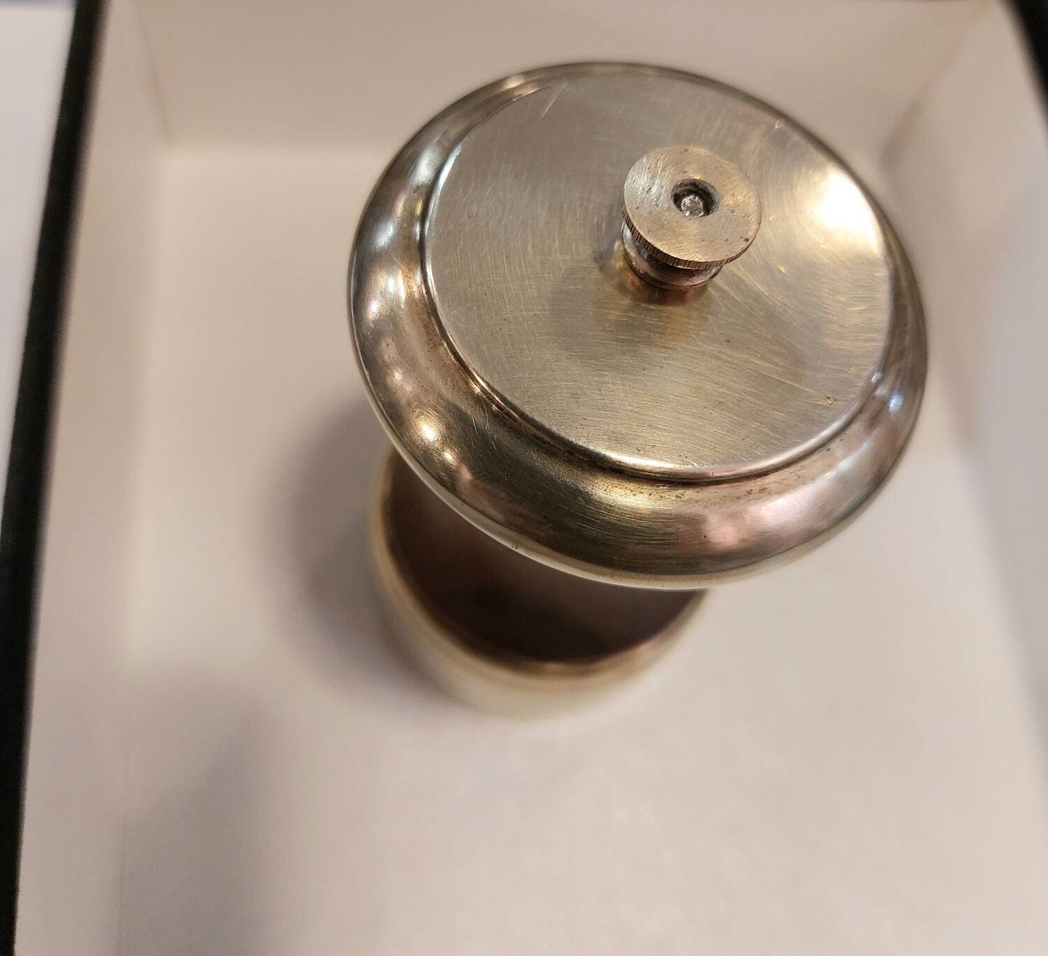 Varnished wood and brushed brass pepper mill