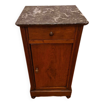 Antique wooden bedside table with black marble top
