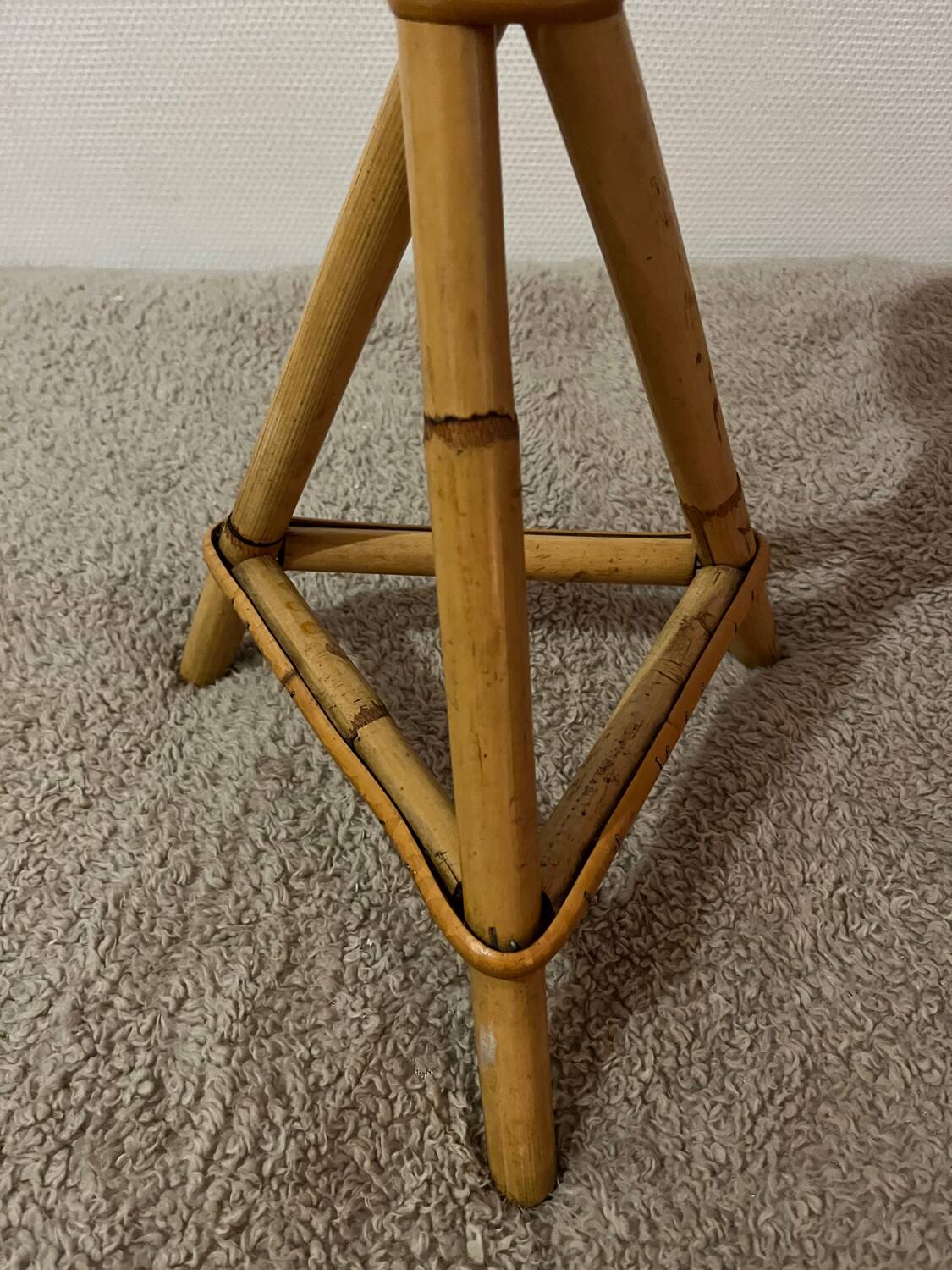 Plant holder or side table at the end of a bamboo sofa