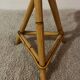 Plant holder or side table at the end of a bamboo sofa