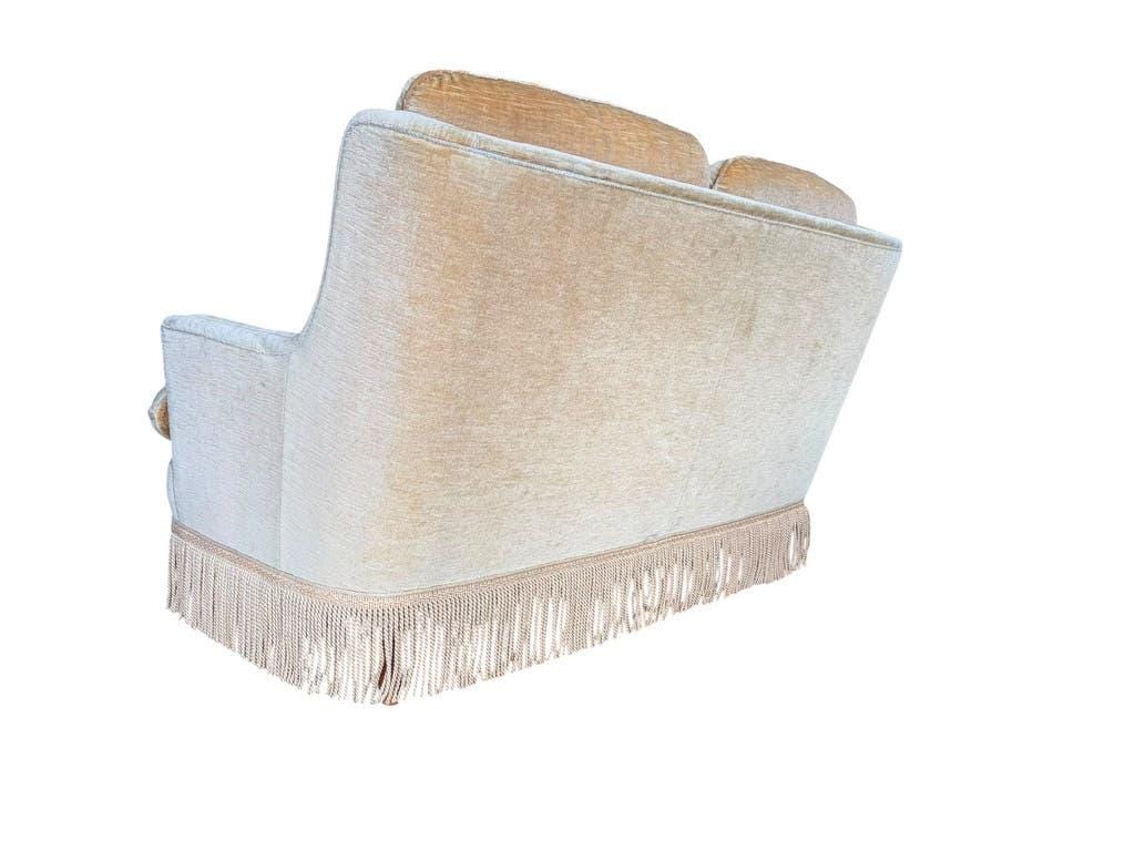 Vintage beige two-seater sofa with fringes
