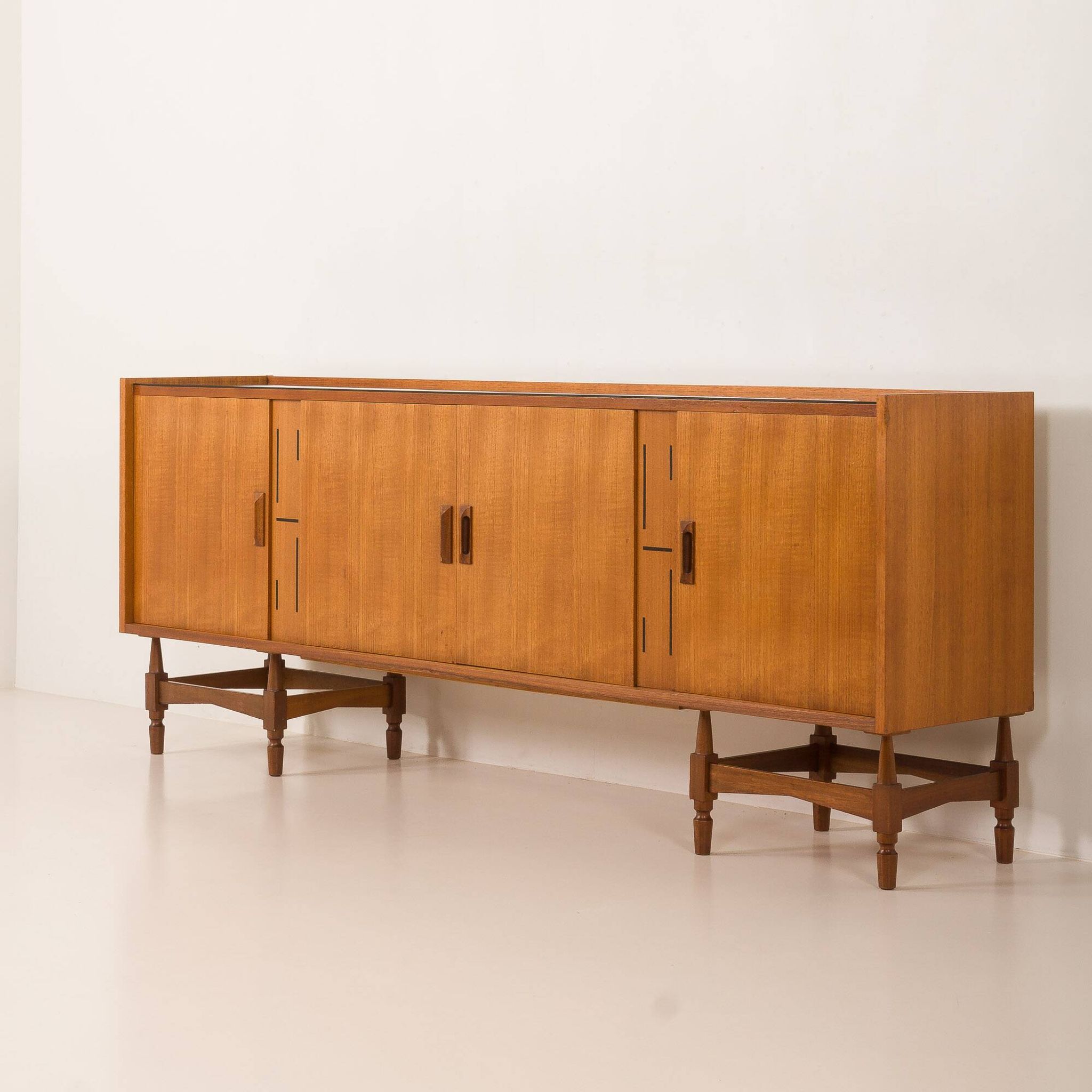Itaian mid century teak sideboard with black glass top and inlays, 1970s