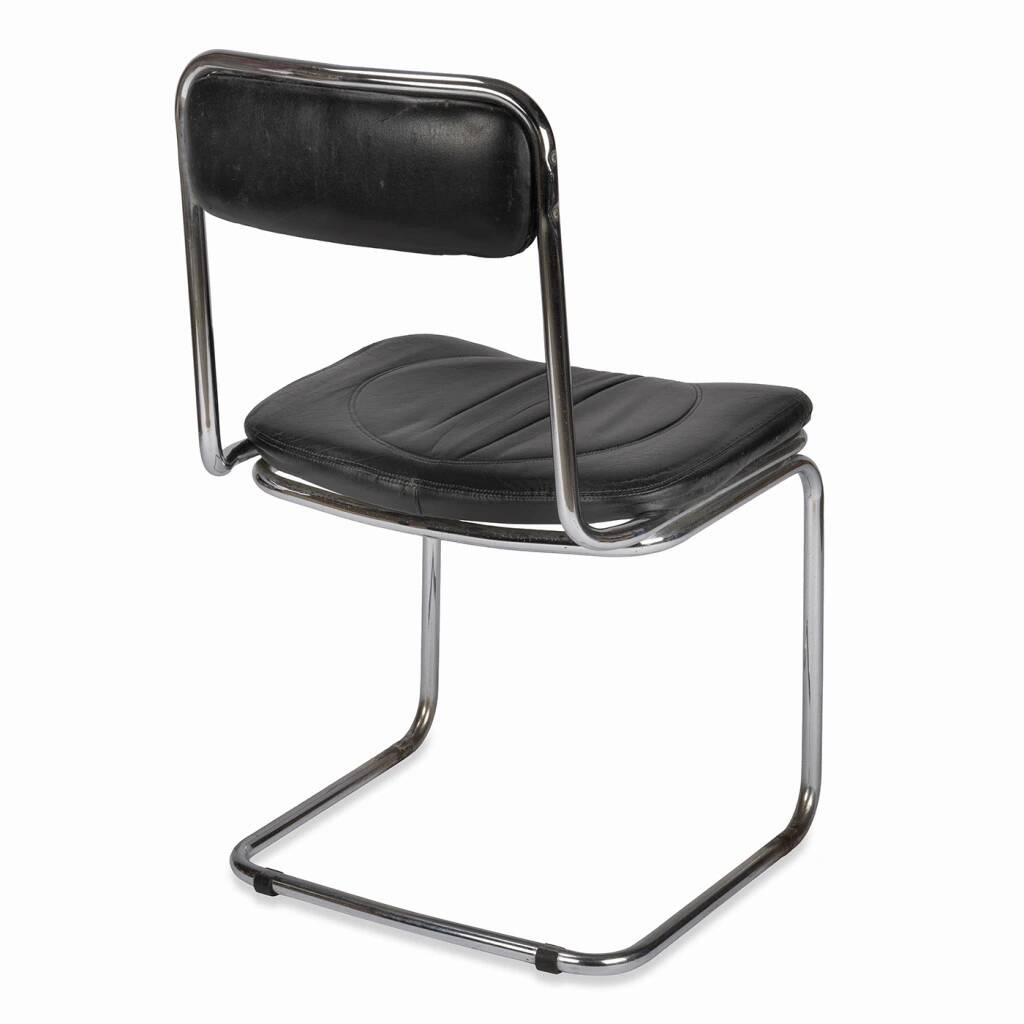 Tube chair with chrome steel base and seat and backrest made of soft black leatherette.