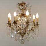 French Louis XV chandelier with 8 lights in gilded bronze, glass and crystal.
