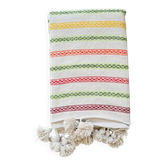 Moroccan plaid made of handwoven wool, decorated with stripes and pom-poms.