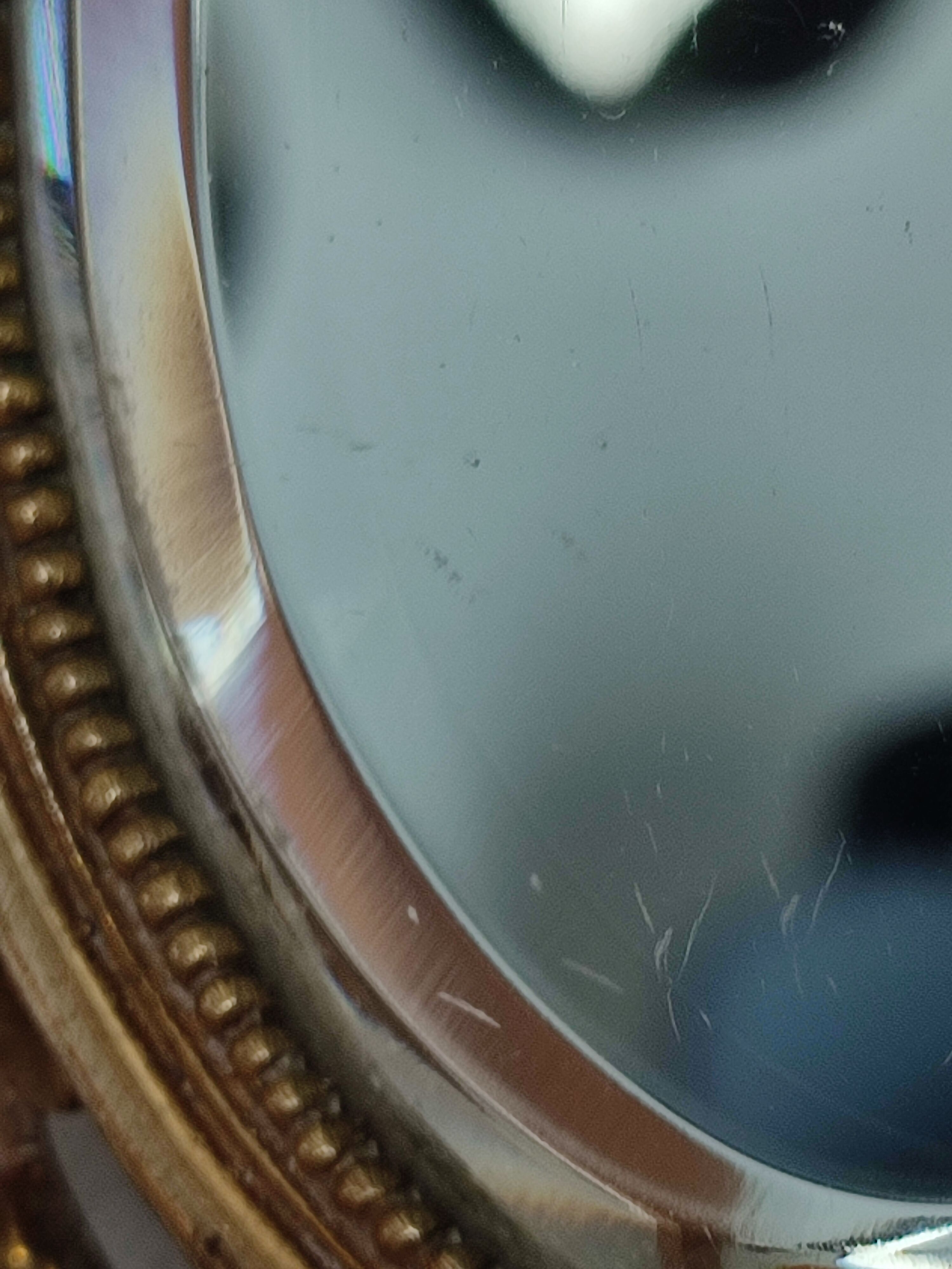 Antique hand-facing mirror in bronze and beveled glass