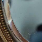 Antique hand-facing mirror in bronze and beveled glass