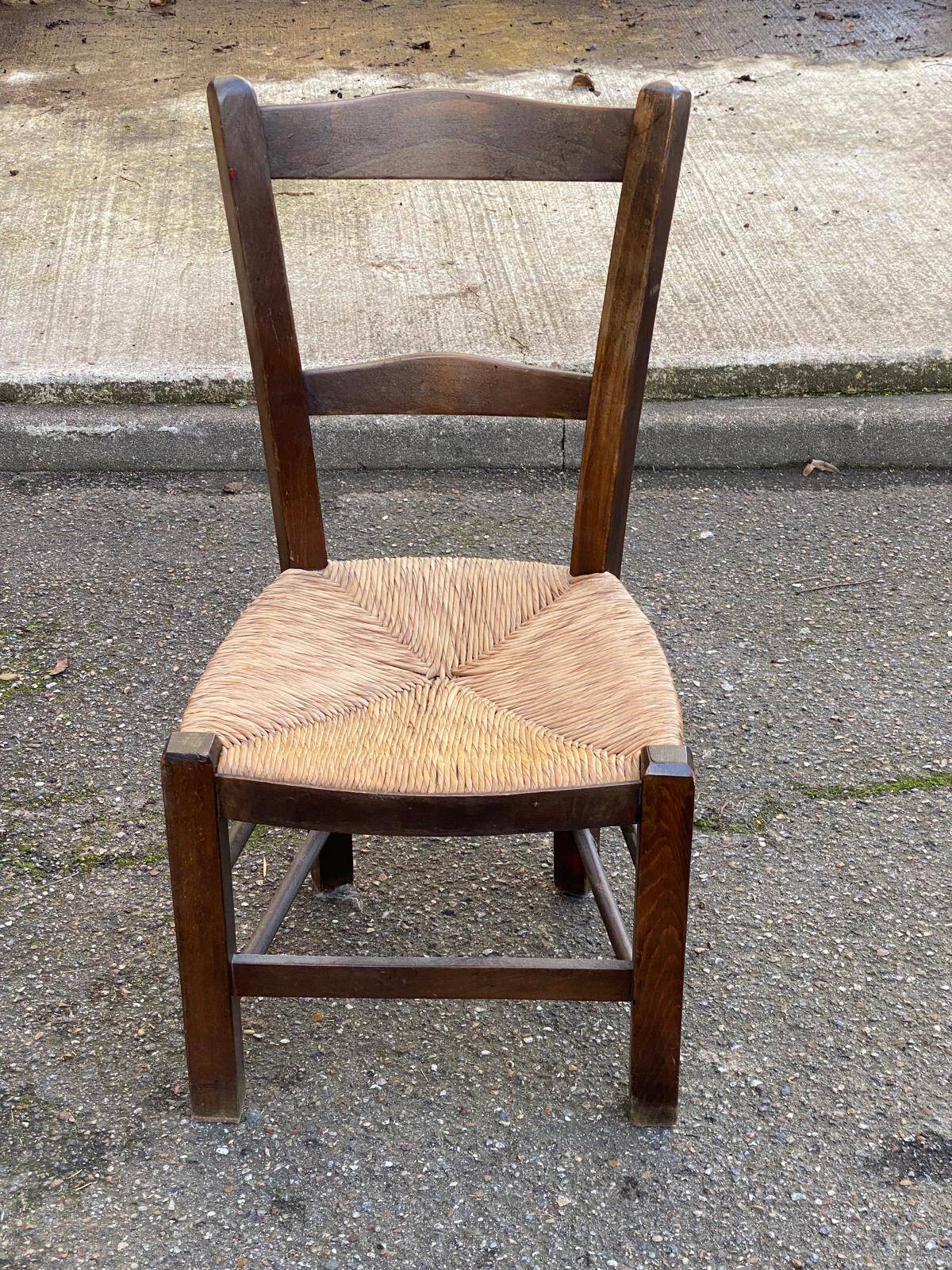 Solid wood chair in dark oak with rush seating, Louis Philippe style.