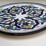 Round ceramic plate with hand-painted decoration