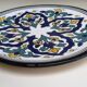 Round ceramic plate with hand-painted decoration