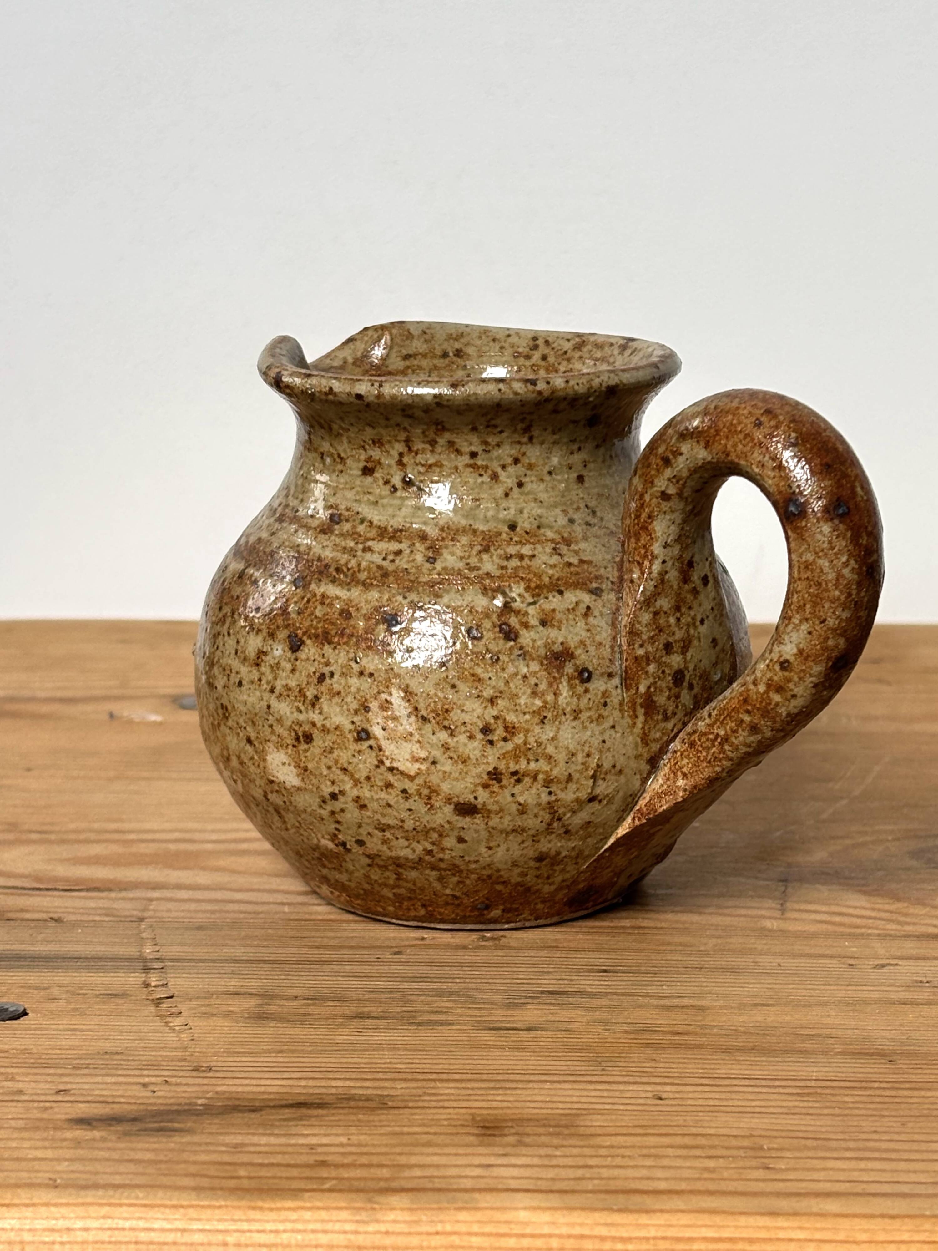 Small beige speckled stoneware pitcher