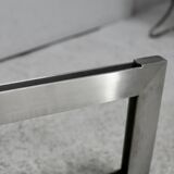 Coffee table with steel base and smoked glass slab. Circa 197