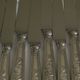 Set of 12 knives with silver metal handles and stainless steel blades.
