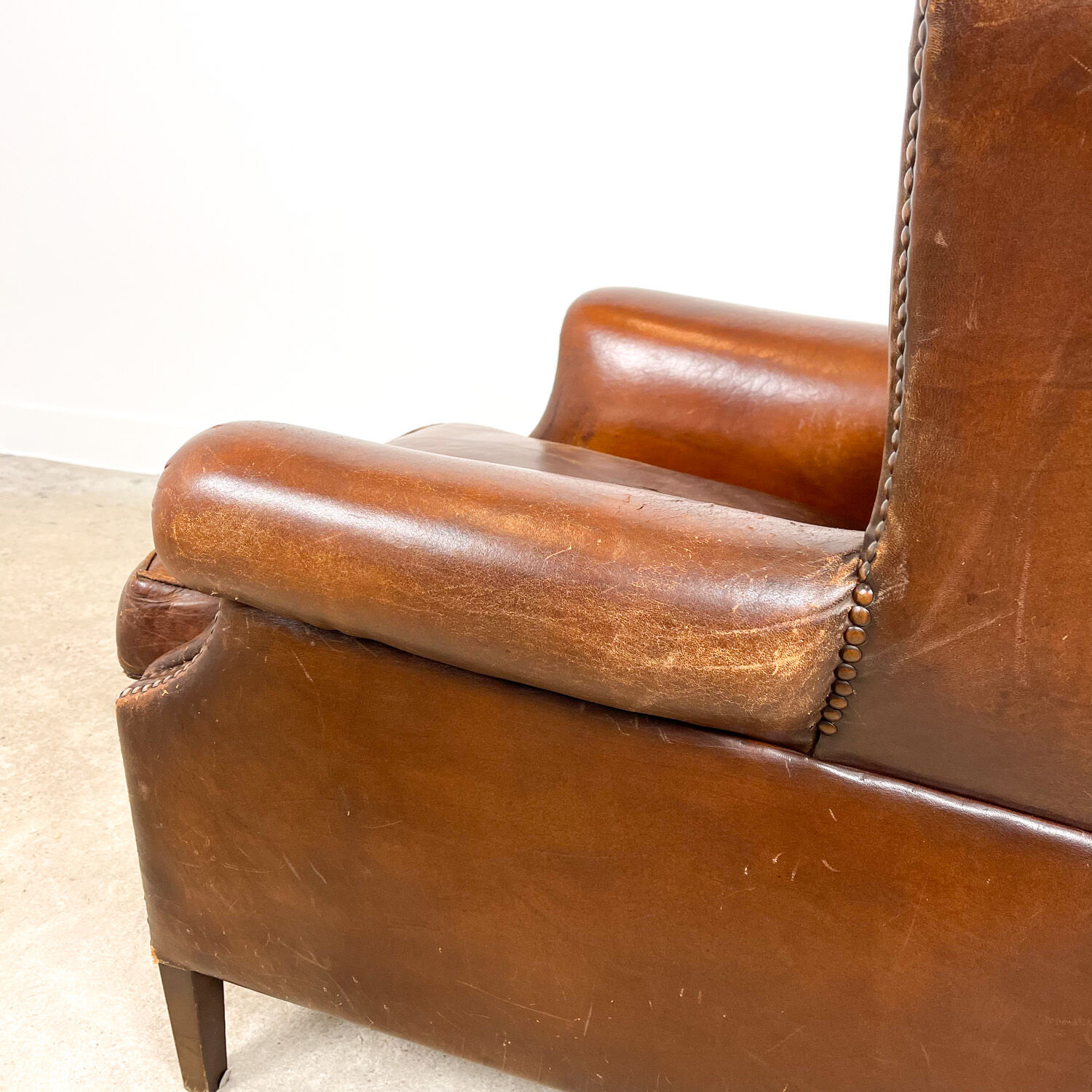 Dark brown sheep leather wingback armchair vintage