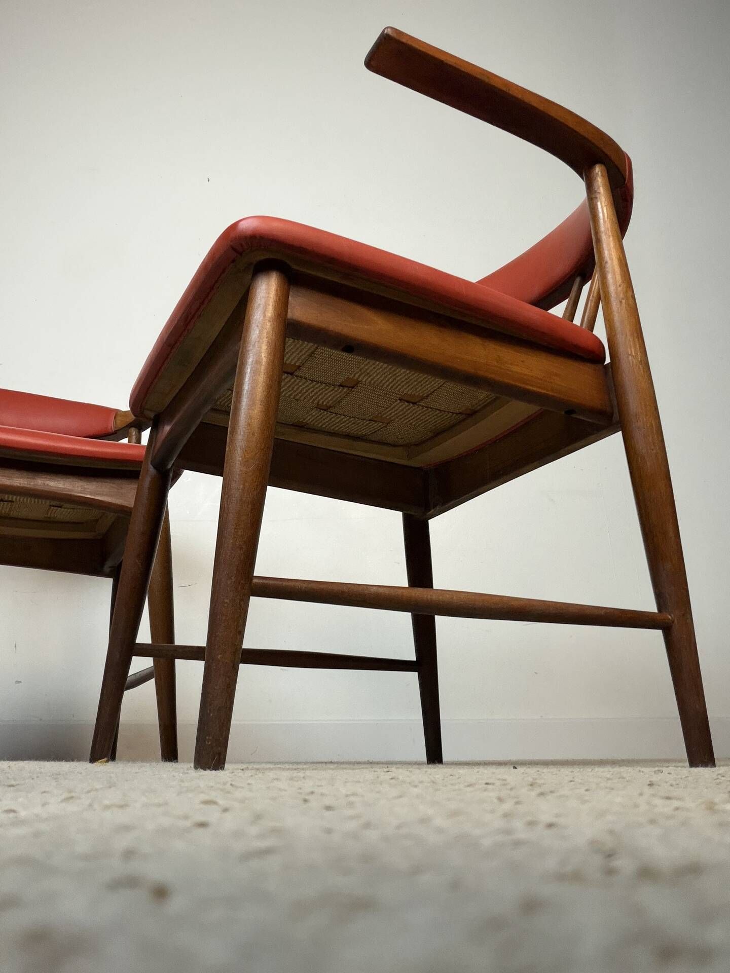Pair of Scandinavian armchairs in teak and red faux leather – 1960s