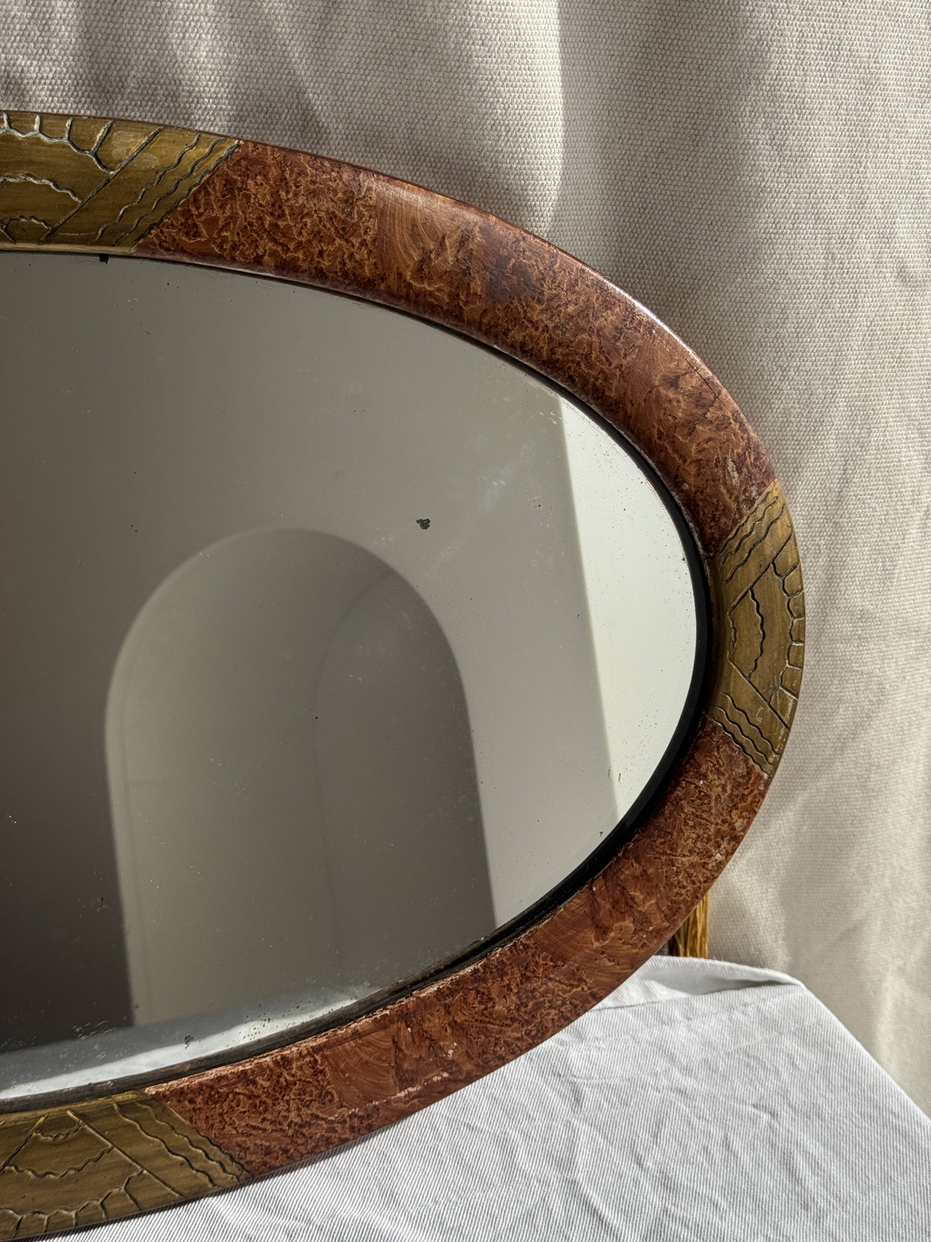 Small oval Art Deco mirror in brown and gold 33x54.