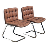 Pair of leather chairs by Robert Haussman