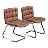 Pair of leather chairs by Robert Haussman