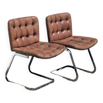 Pair of leather chairs by Robert Haussman