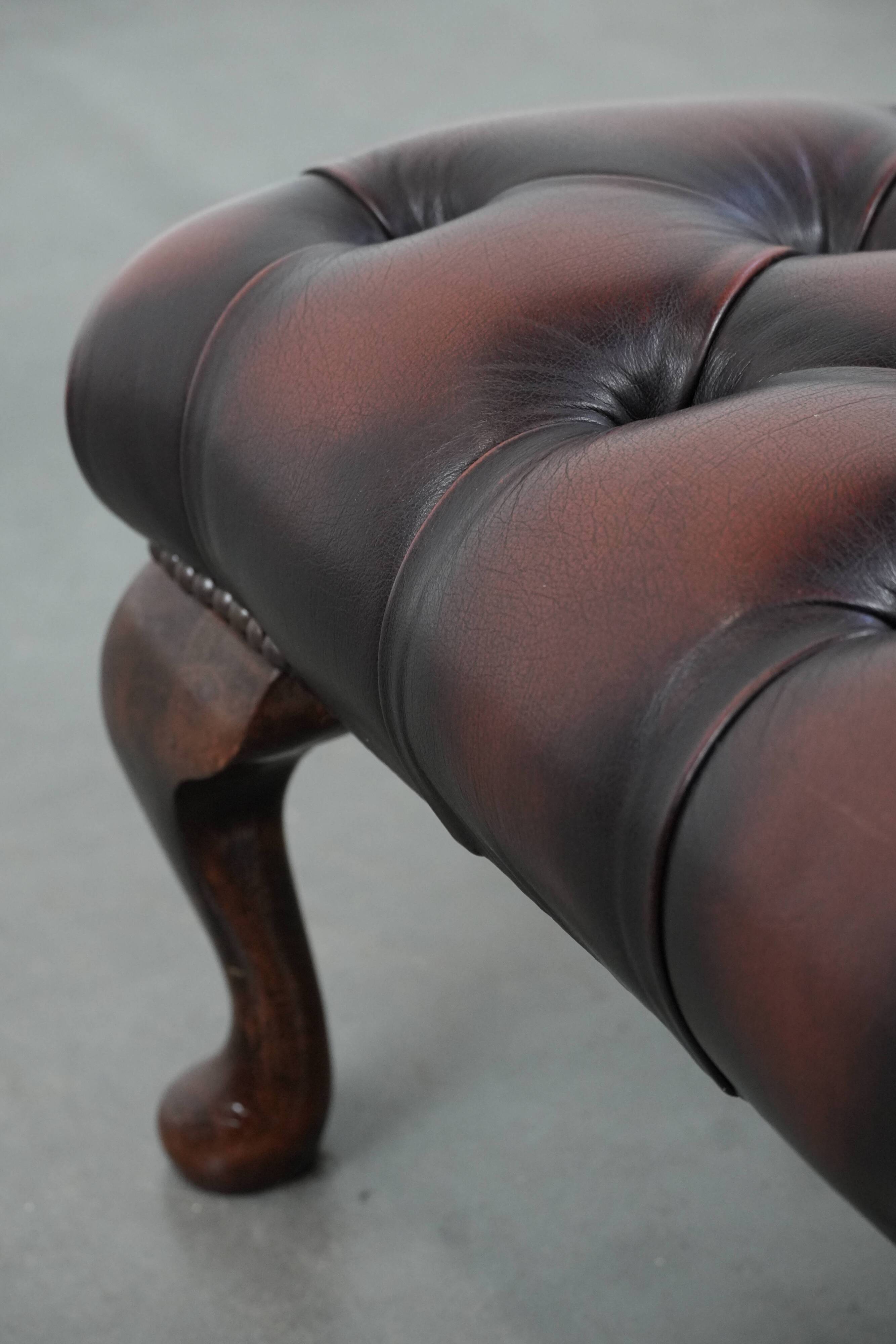 Dark brown chesterfield ottoman in cowhide leather