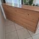 Antique wooden sideboard with three sliding glass doors.