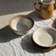 Small thick stoneware bowl with a stylised flower pattern in white on the outside, b