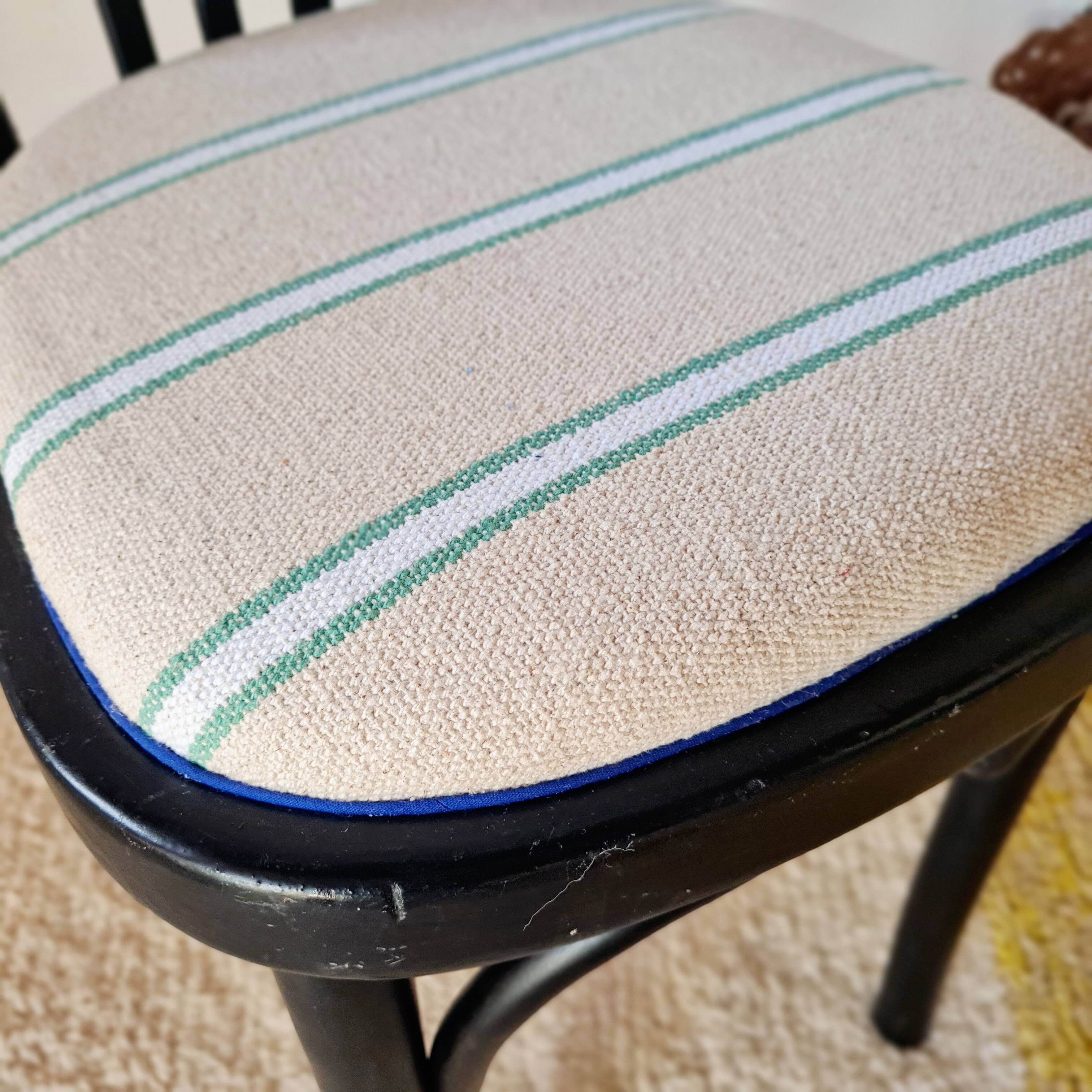 Curved black wooden bistro chair with striped seat