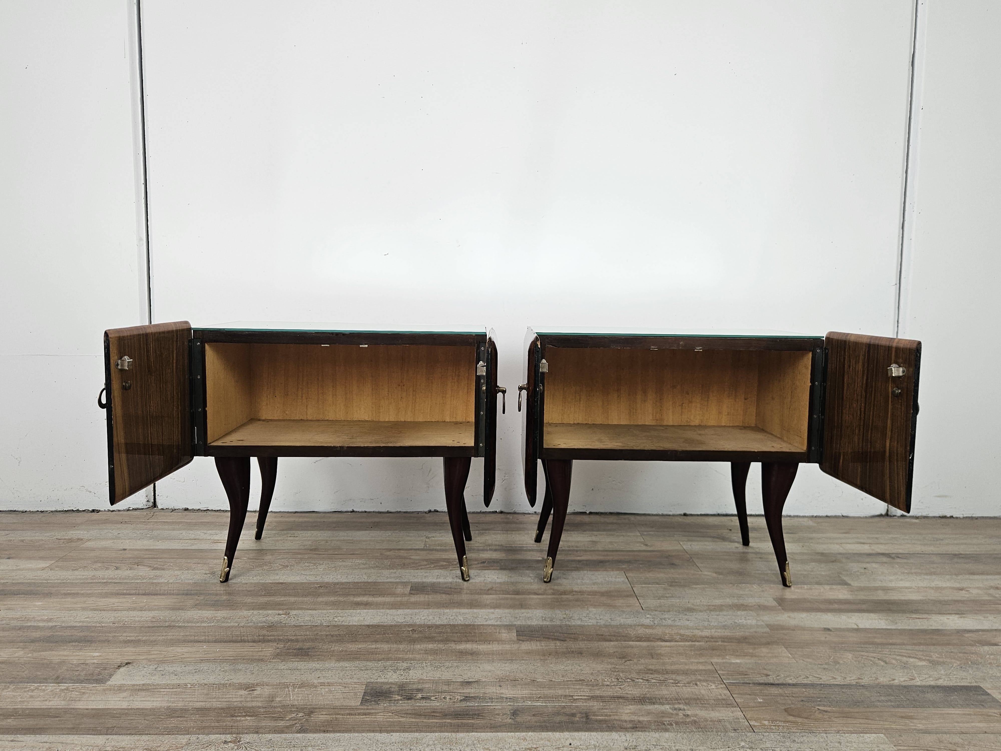 Mid-century mahogany bedside tables with mirrored tops.