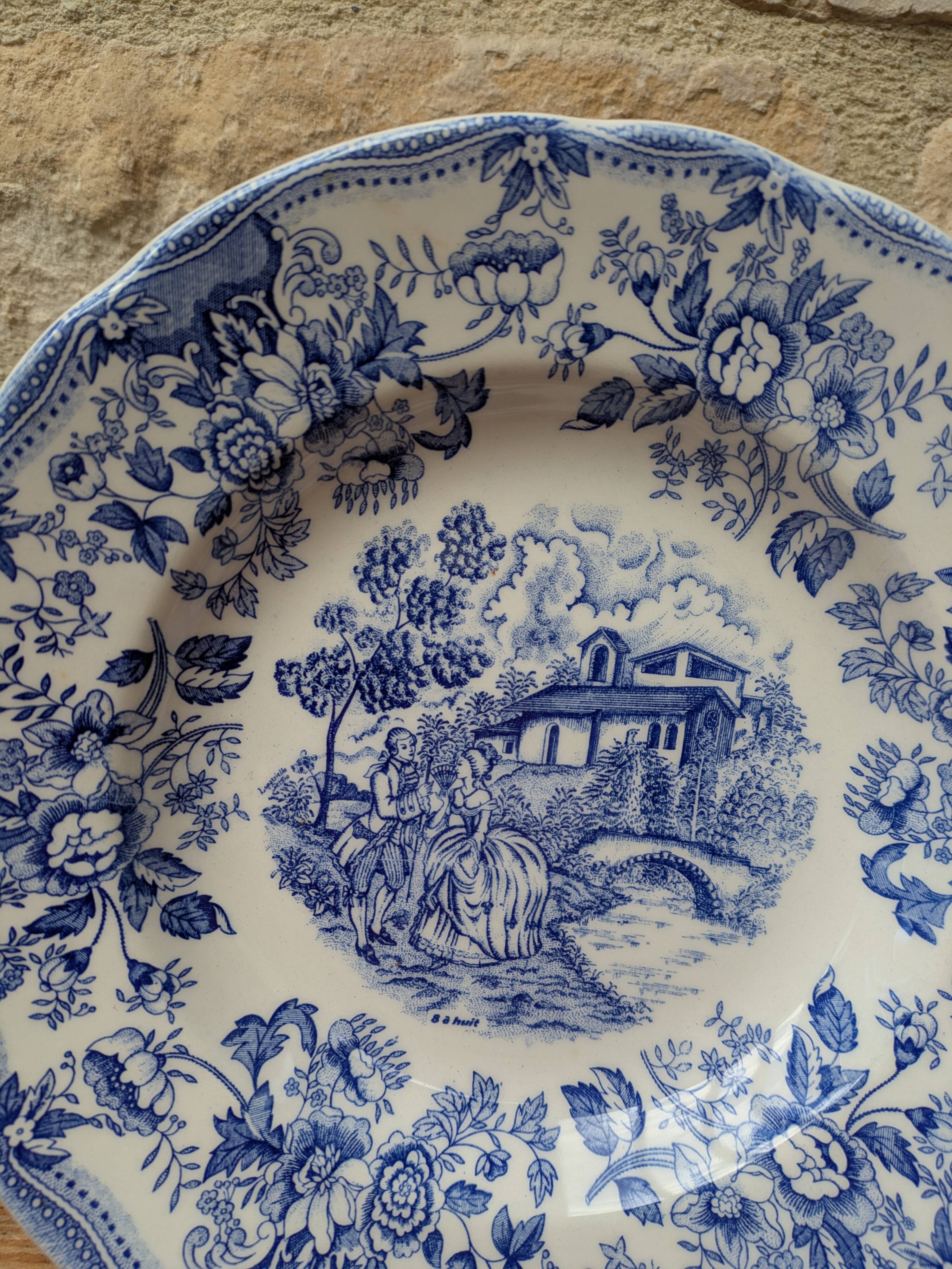 Old deep plate with blue floral pattern and gallant scene