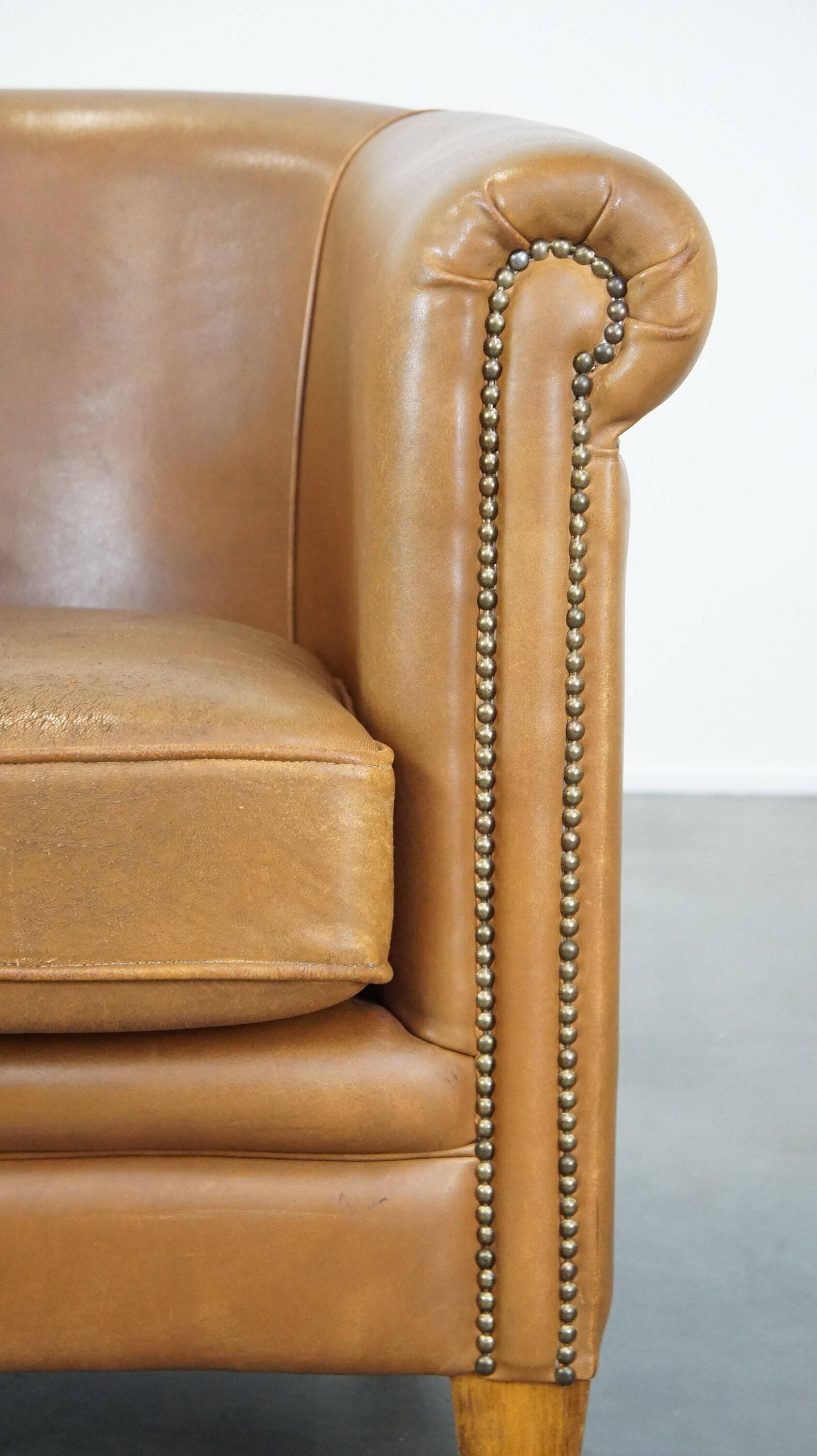 Sheep leather club chair in neutral cognac colour and in good condition
